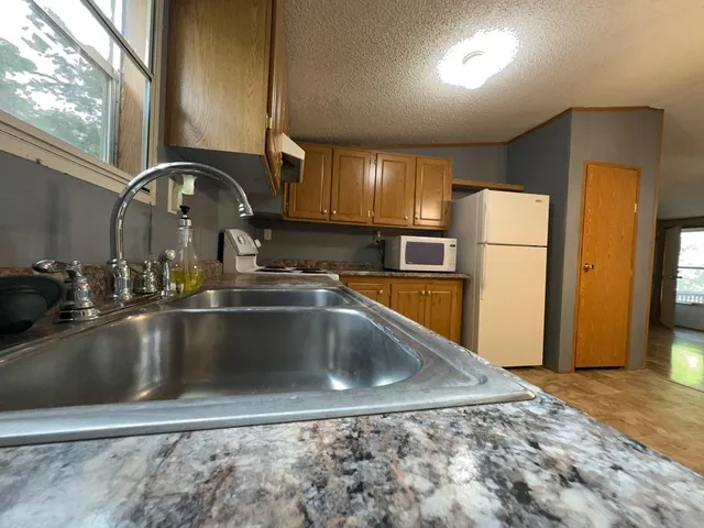 a view of livingroom with kitchen and chandelier