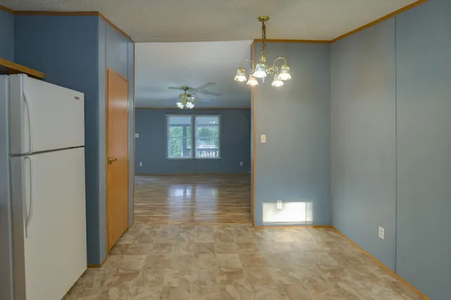 a view of a hallway with a refrigerator