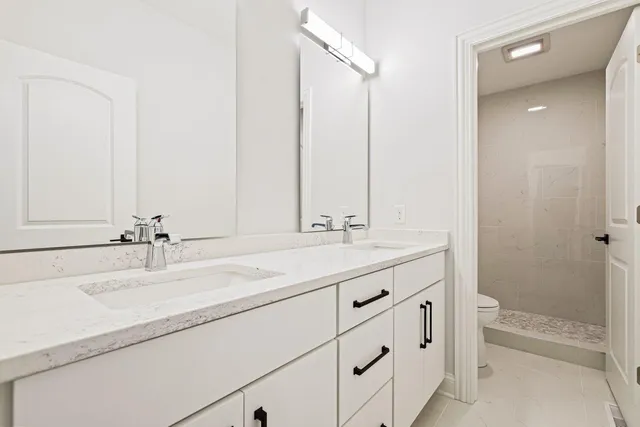 a bathroom with a sink and a mirror with bathtub