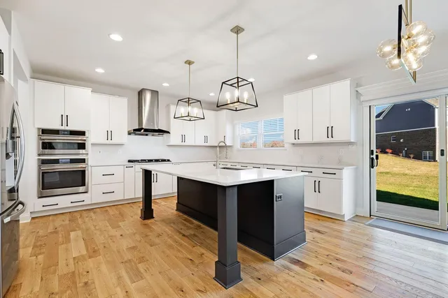 a kitchen with a sink stove and cabinets