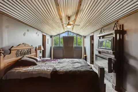 a bedroom with a bed and a chandelier