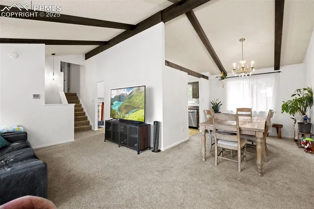 a dining room with furniture and a floor to ceiling window
