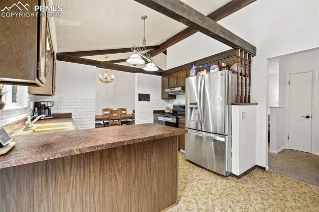 a kitchen with stainless steel appliances granite countertop a sink refrigerator and microwave