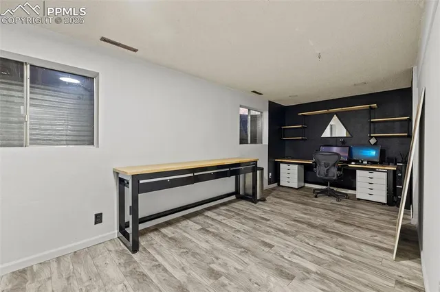a living room with furniture a flat screen tv and kitchen view