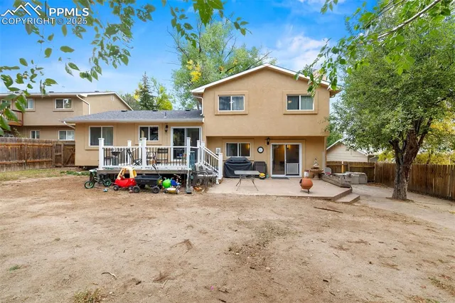 a view of a house with a yard patio and a fire pit