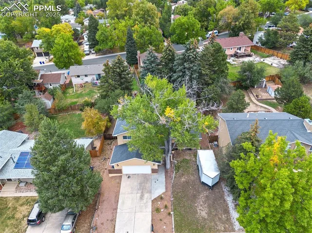 an aerial view of a house with a yard