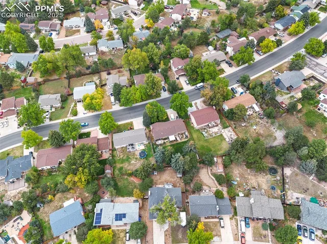 an aerial view of residential houses with outdoor space