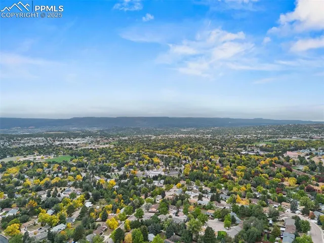 an aerial view of residential building and trees around