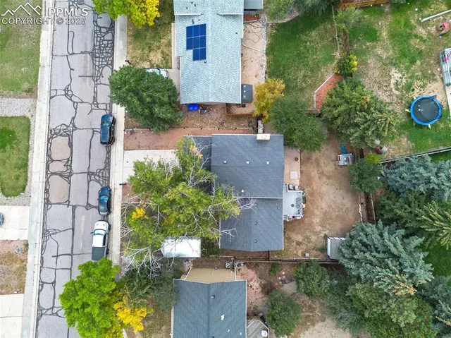 an aerial view of a house with a yard