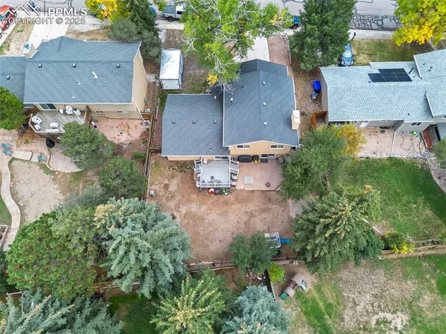 an aerial view of residential houses with outdoor space and lake view