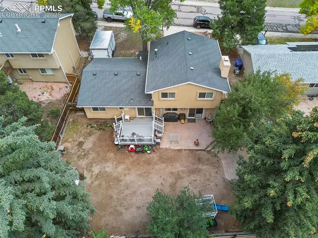 an aerial view of multiple houses with yard