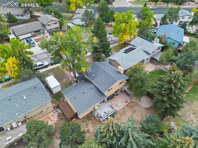an aerial view of multiple houses with yard