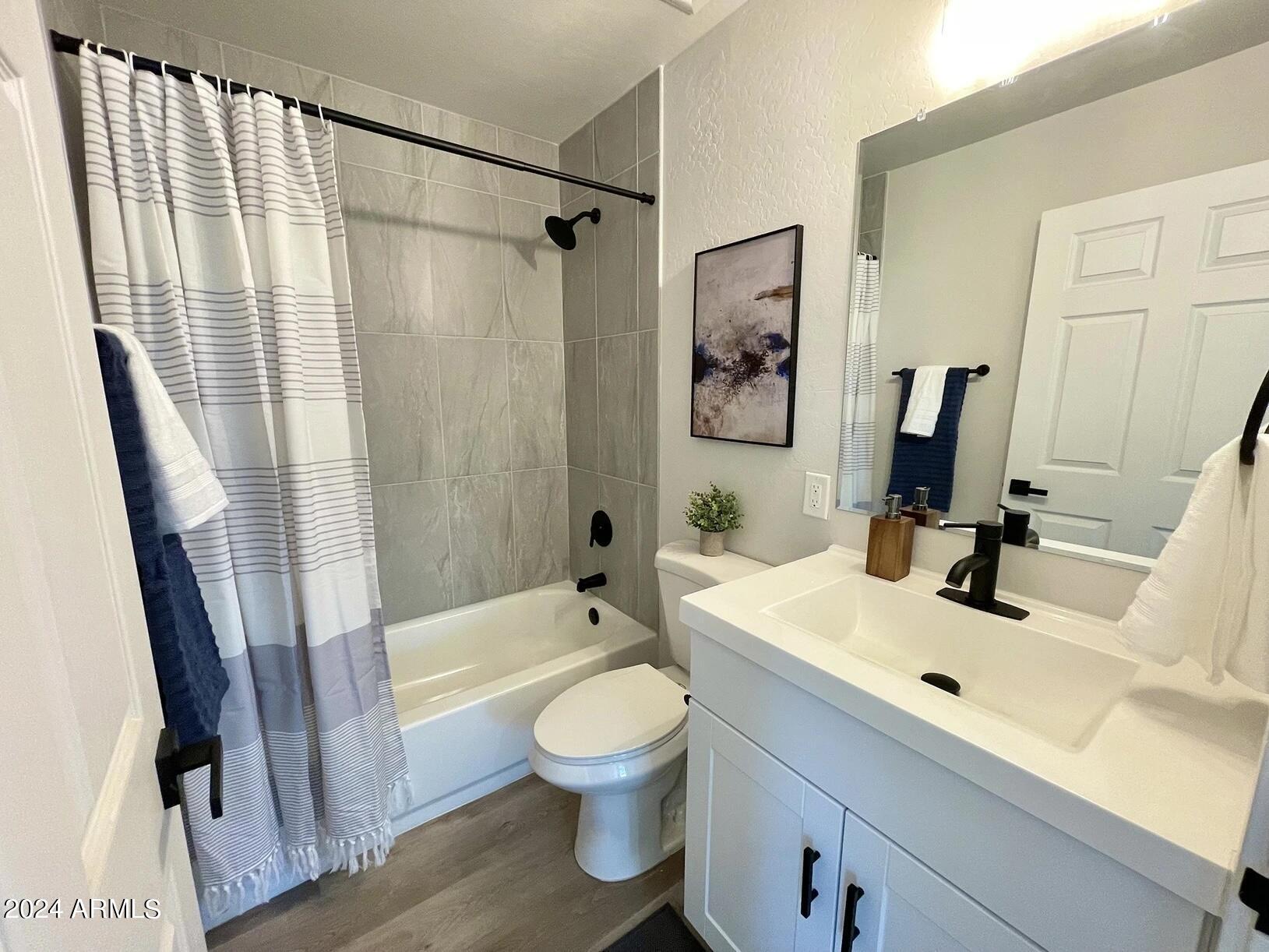 815 East Roma Avenue, Unit 5 Phoenix, AZ 85014 - Photo 13 of 28 a bathroom with a sink a toilet and a large mirror