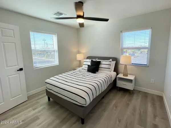a bedroom with a bed and a chandelier