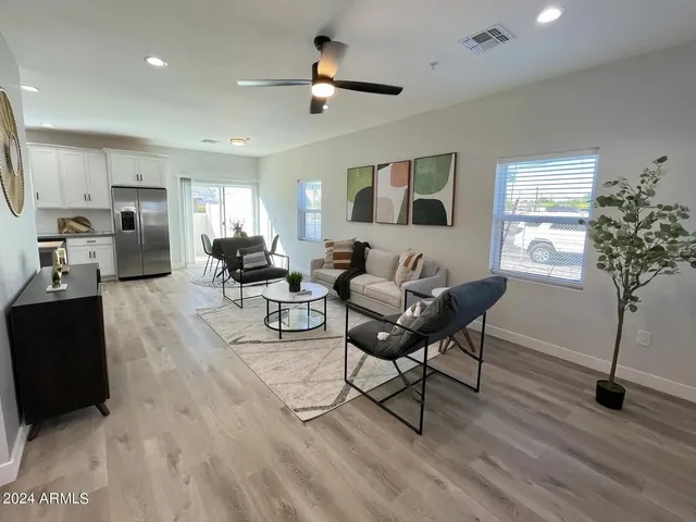 a living room with furniture and a potted plant