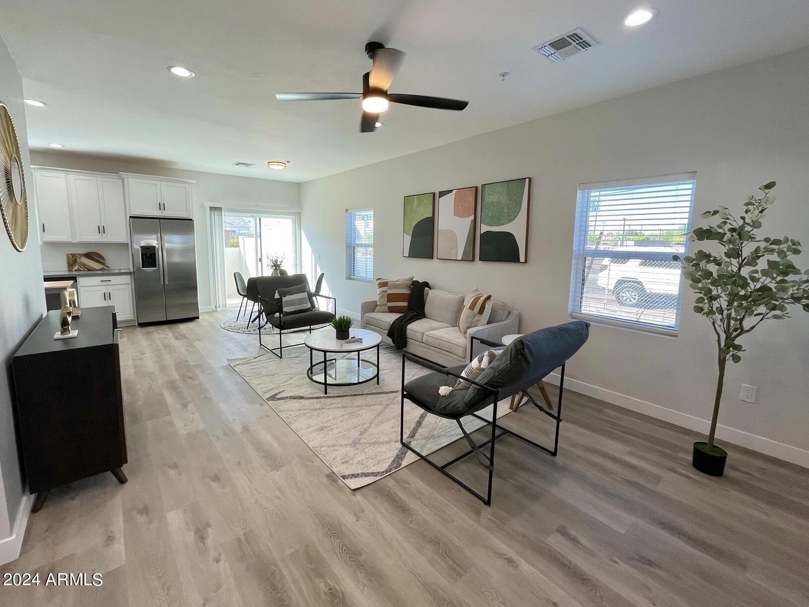 815 East Roma Avenue, Unit 5 Phoenix, AZ 85014 - Photo 2 of 28 a living room with furniture and a potted plant