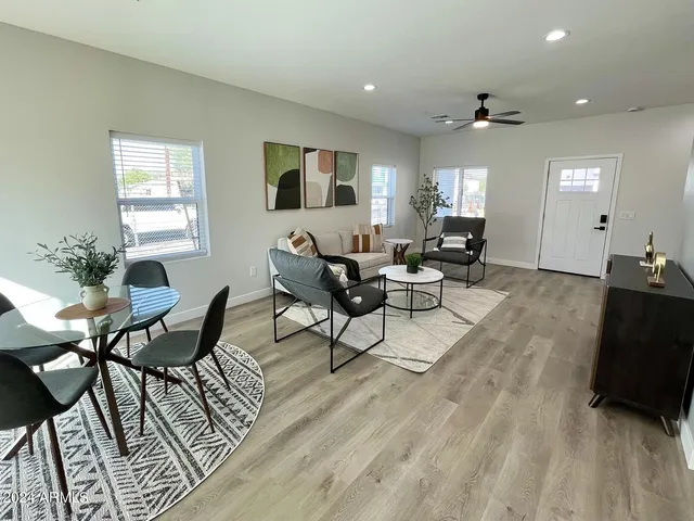a living room with furniture and wooden floor