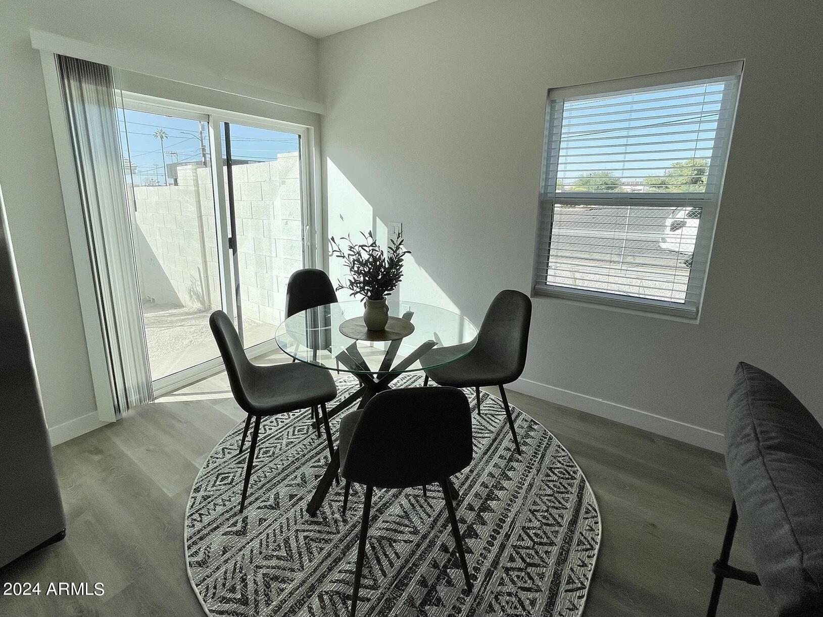 815 East Roma Avenue, Unit 5 Phoenix, AZ 85014 - Photo 7 of 28 a dining room with furniture and window