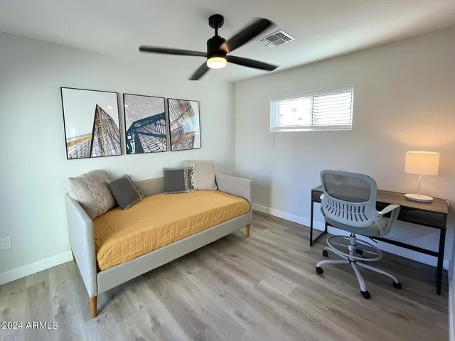 a bedroom with a bed and a chandelier