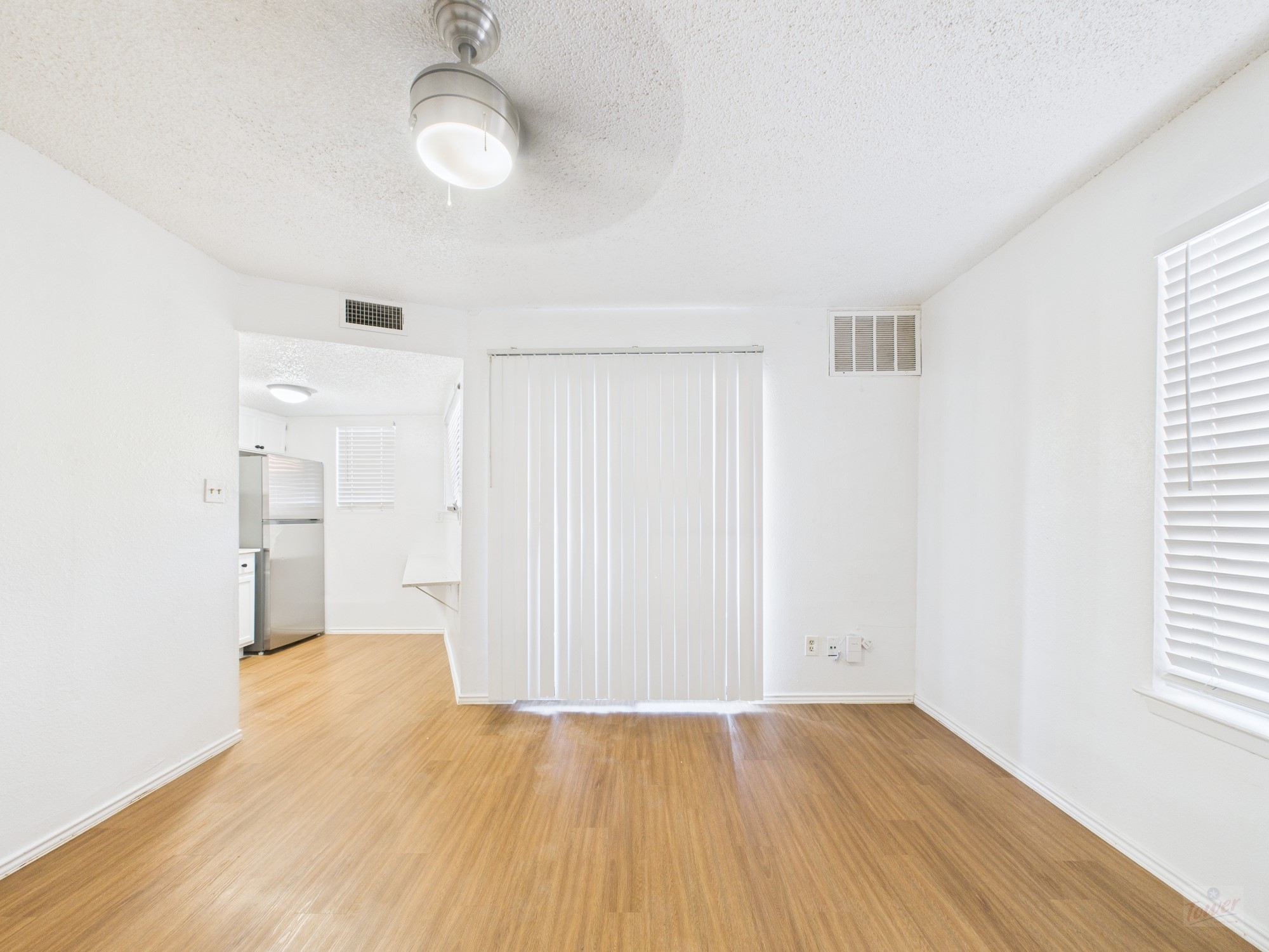 2500 Burleson Road, Unit 201 Austin, TX 78741 - Photo 3 of 20 a view of a room with wooden floor and white walls