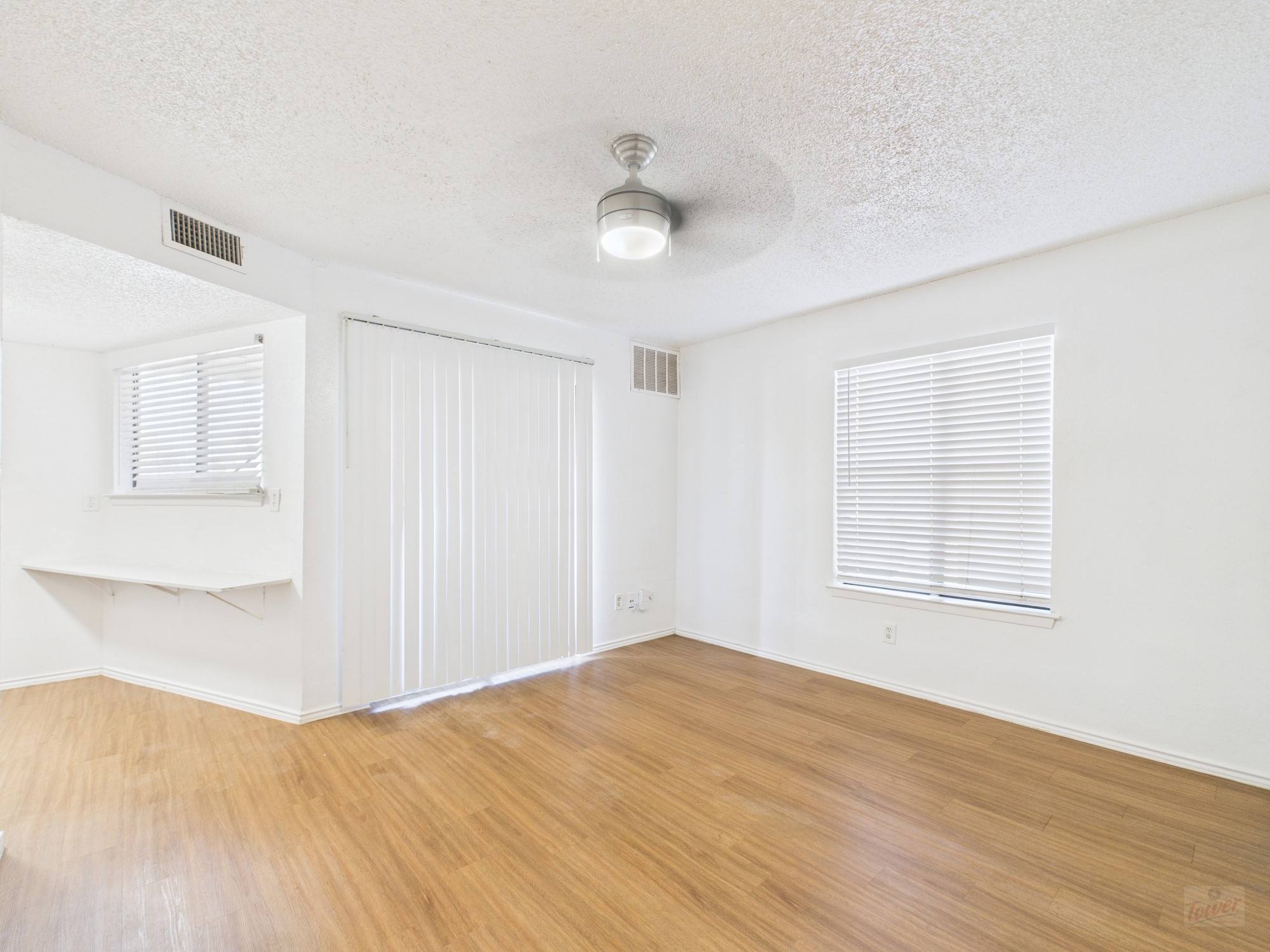 2500 Burleson Road, Unit 201 Austin, TX 78741 - Photo 4 of 20 a view of empty room with wooden floor and fan