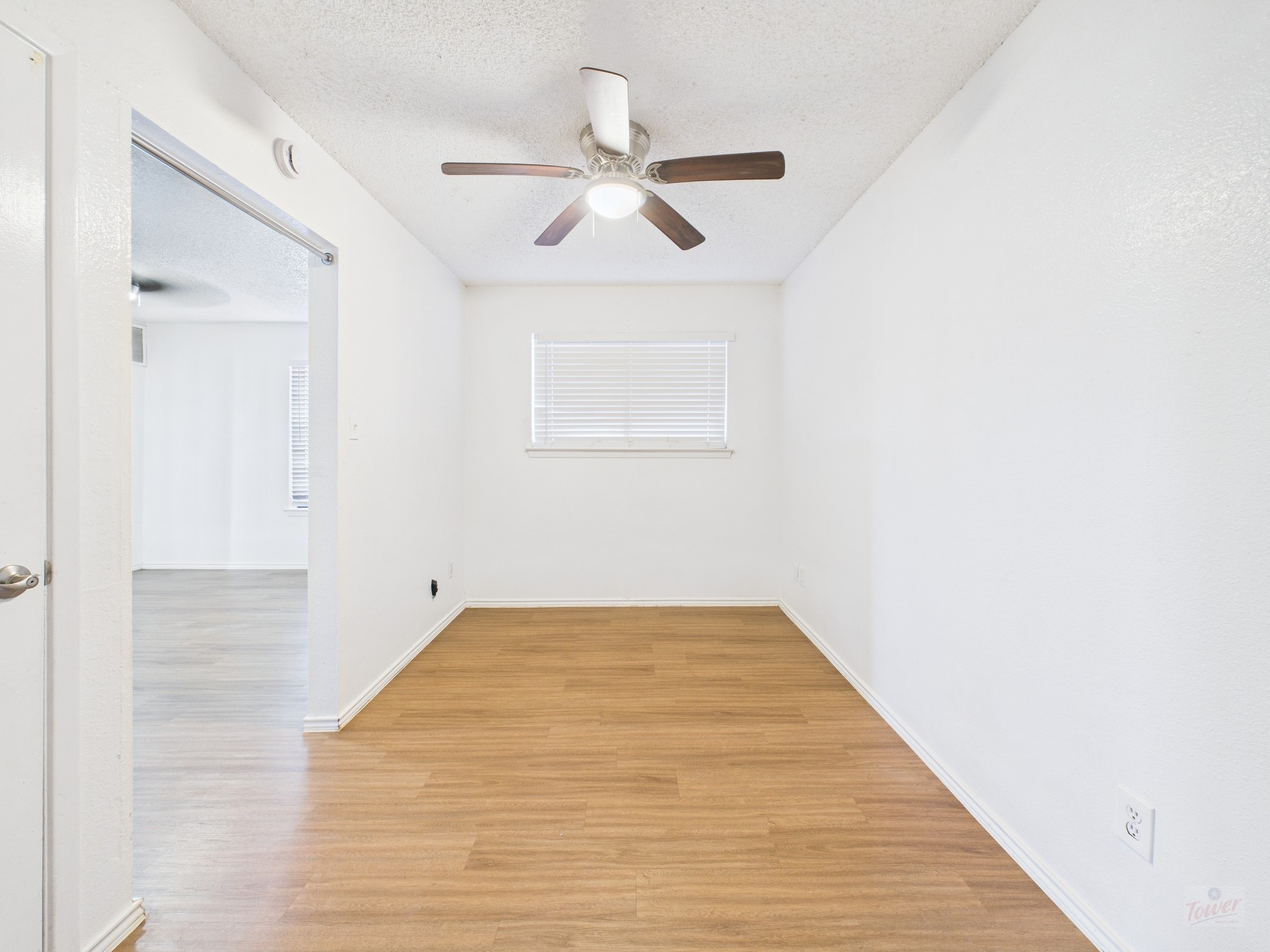 2500 Burleson Road, Unit 201 Austin, TX 78741 - Photo 10 of 20 a view of a room with wooden floor and ceiling fan