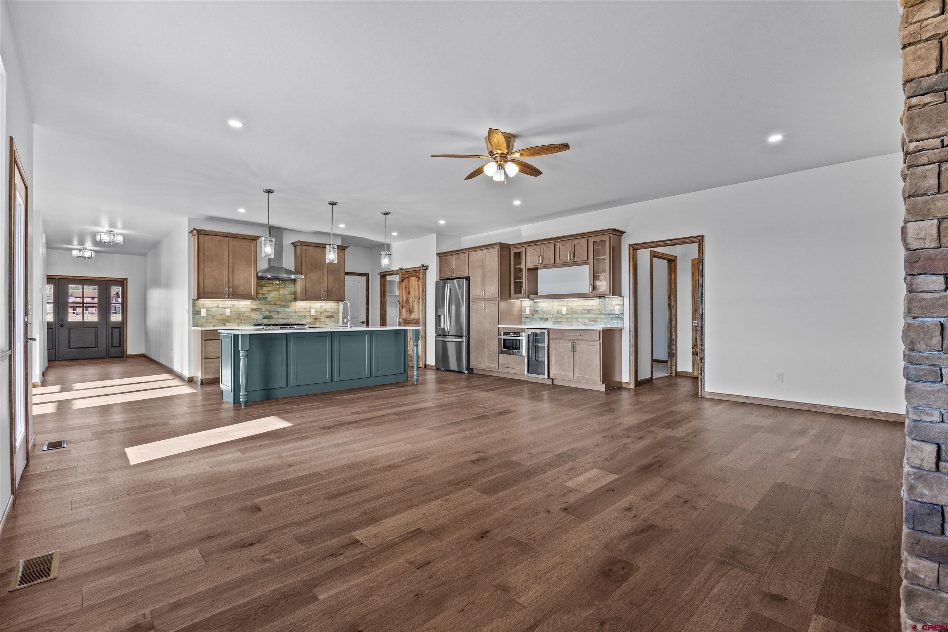 21470 Government Springs Road Montrose, CO 81403 - Photo 11 of 42 a view of kitchen with cabinets and wooden floor