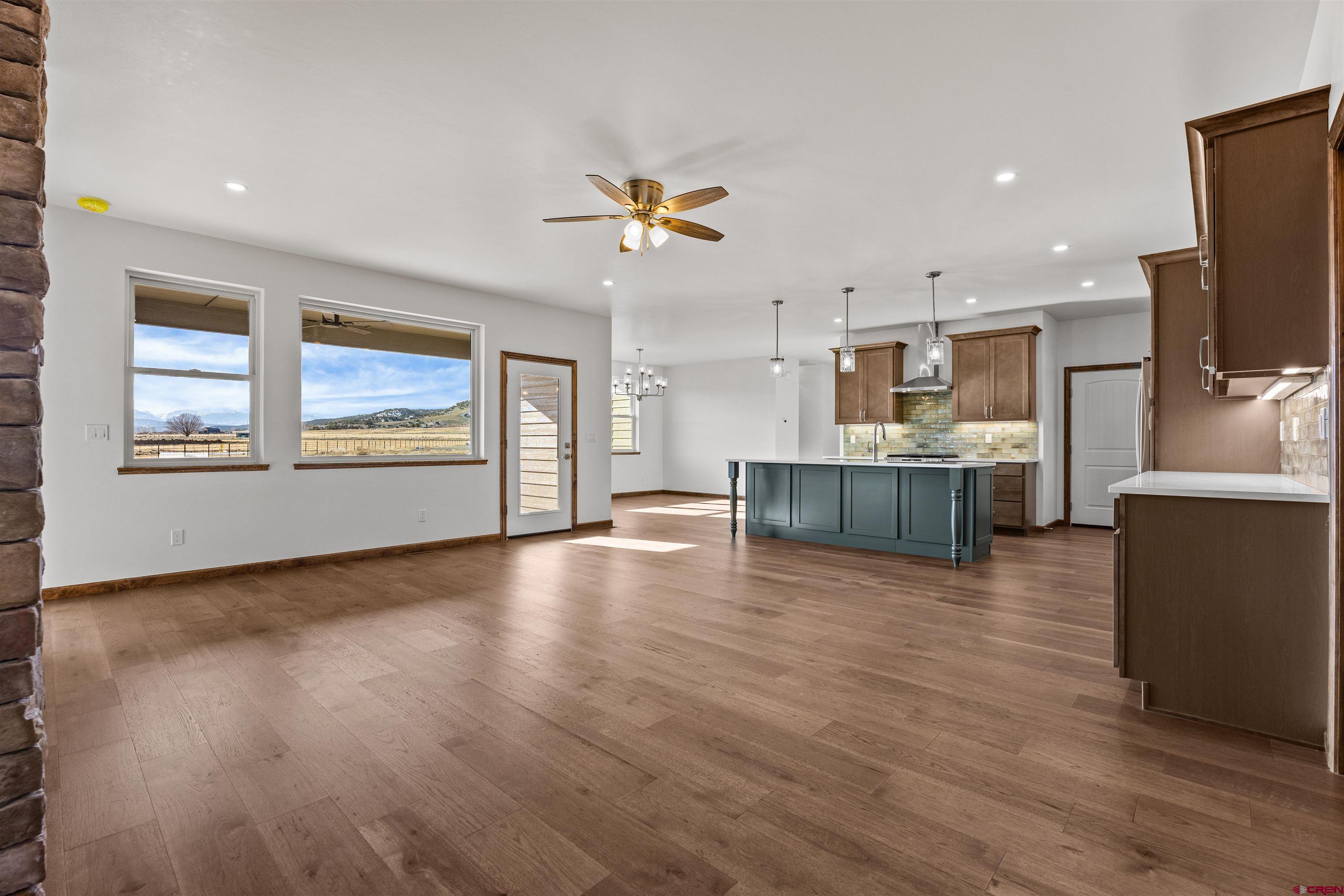 21470 Government Springs Road Montrose, CO 81403 - Photo 14 of 42 a view of a living room with kitchen and flat screen tv
