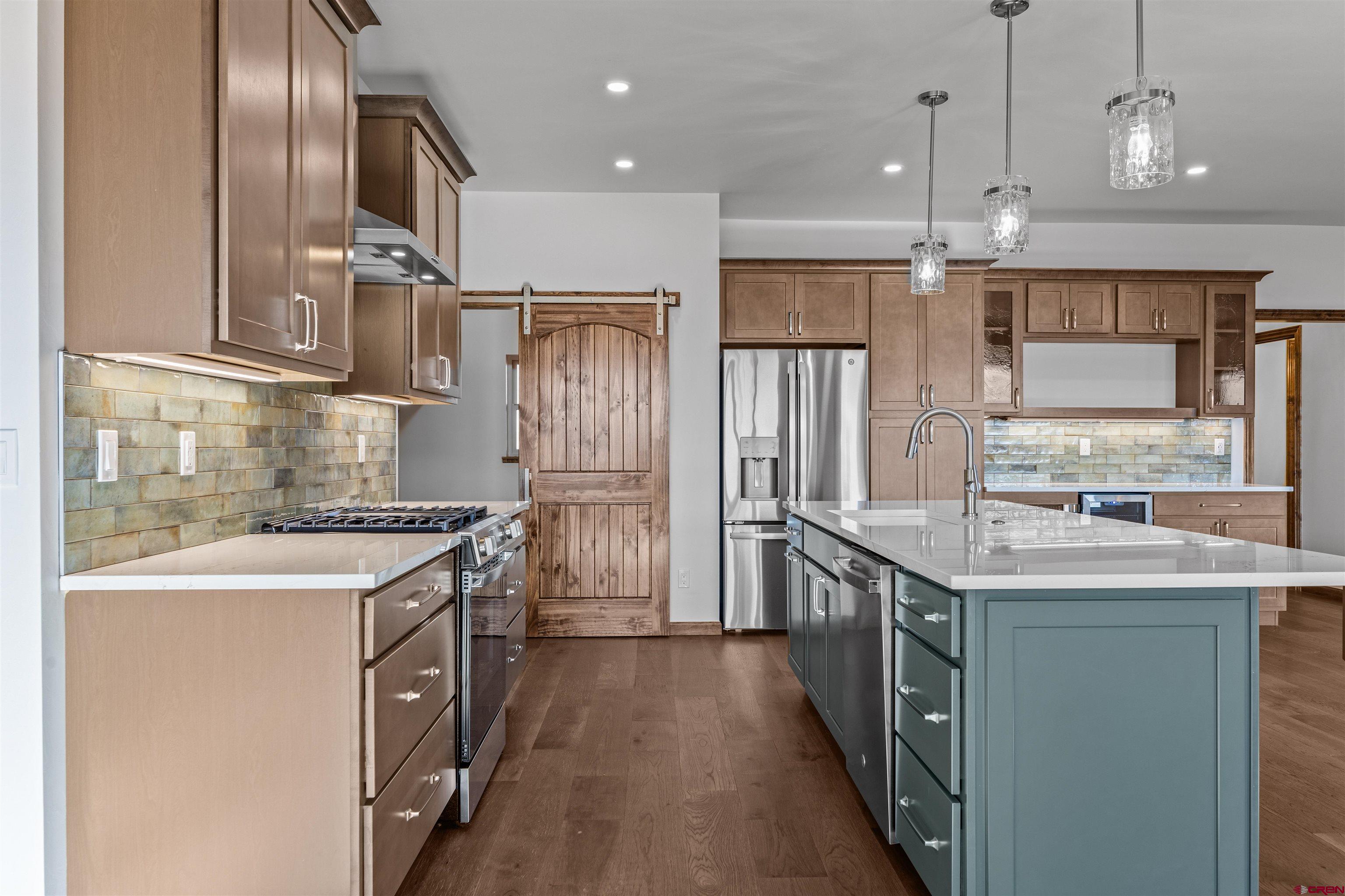 21470 Government Springs Road Montrose, CO 81403 - Photo 18 of 42 a kitchen with stainless steel appliances granite countertop a sink a stove and a refrigerator