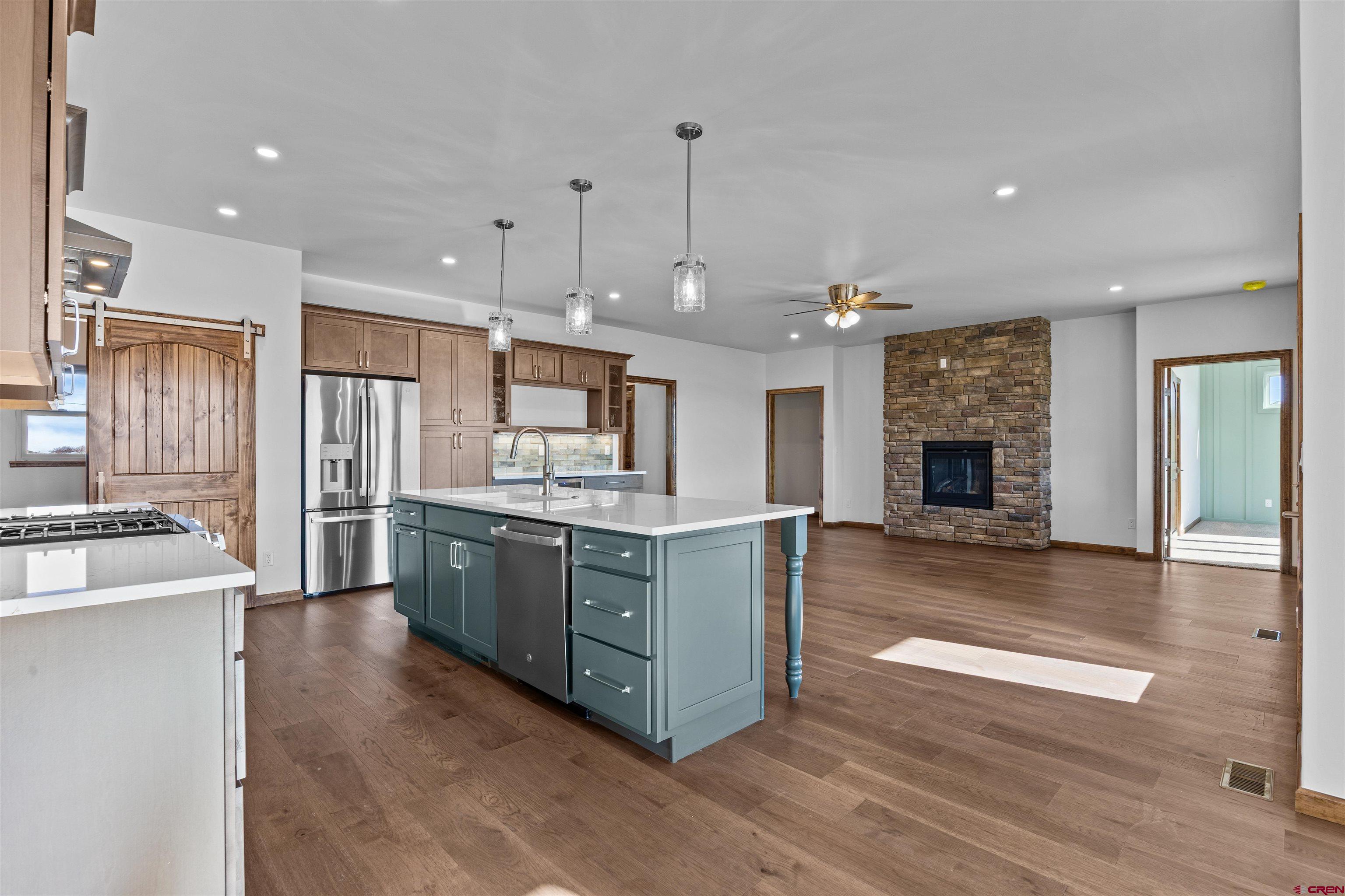 21470 Government Springs Road Montrose, CO 81403 - Photo 20 of 42 a large kitchen with stainless steel appliances granite countertop a stove oven and a refrigerator