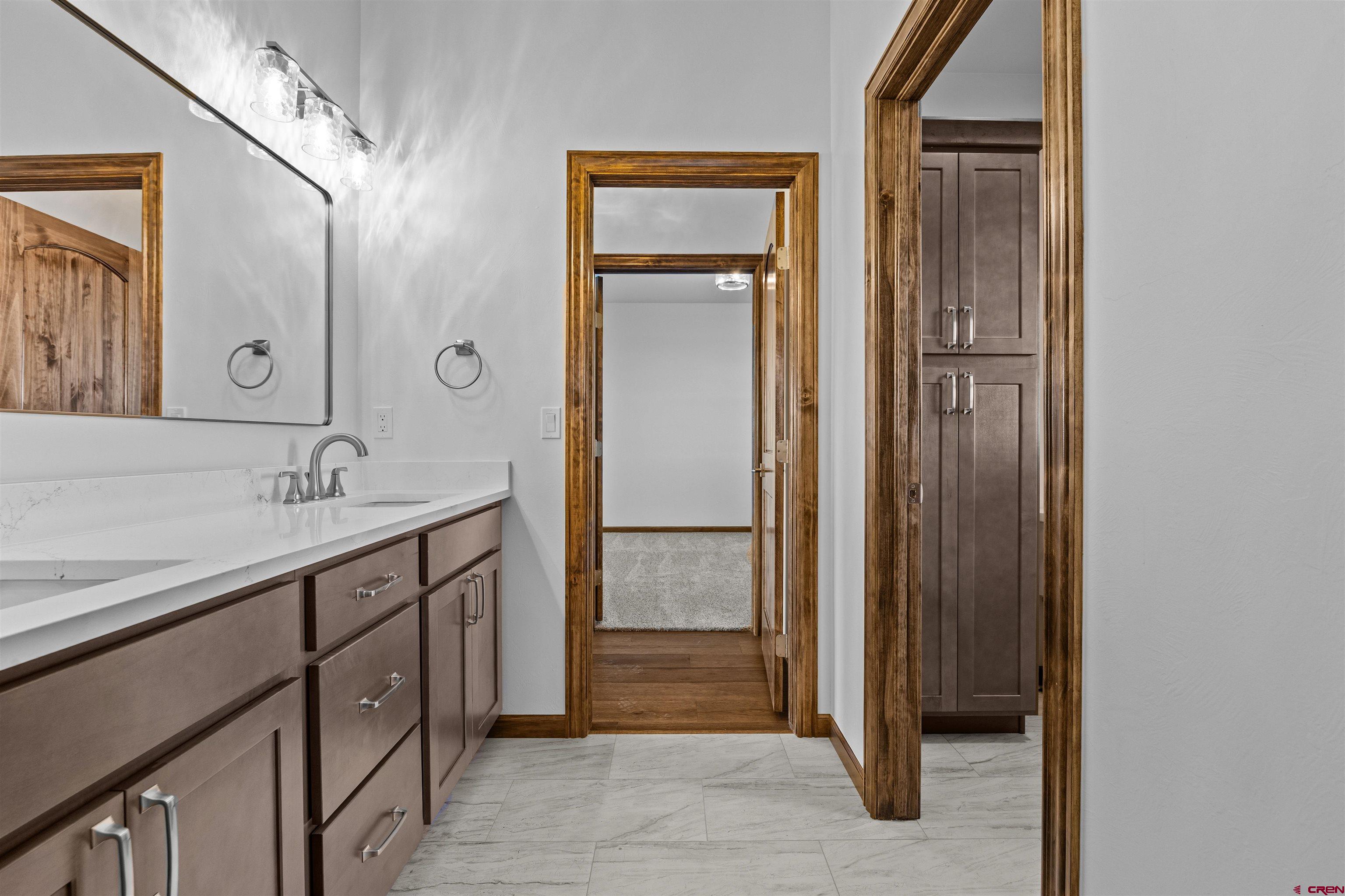 21470 Government Springs Road Montrose, CO 81403 - Photo 30 of 42 a bathroom with a sink a shower and a mirror
