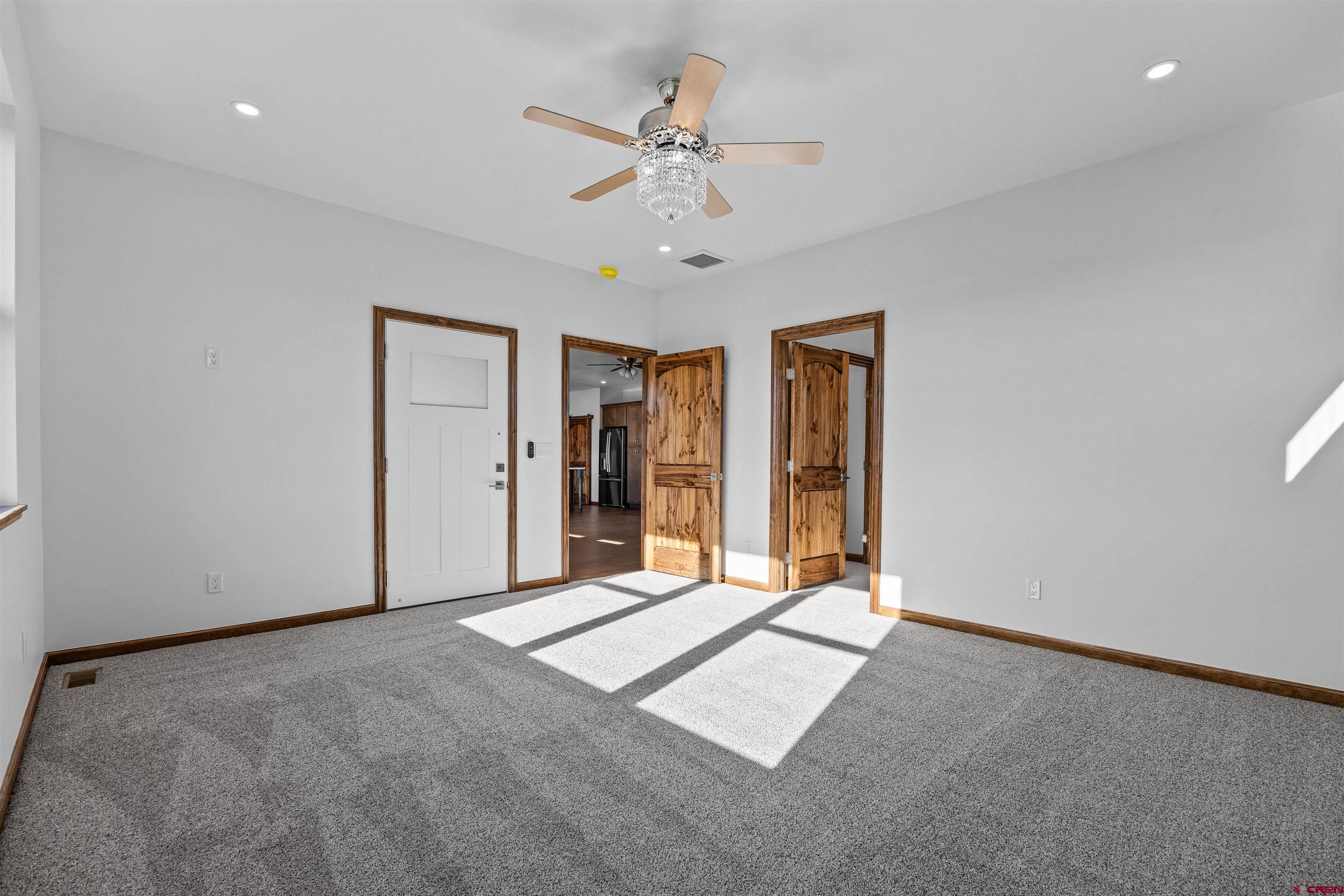 21470 Government Springs Road Montrose, CO 81403 - Photo 3 of 42 an empty room with fan and hallway