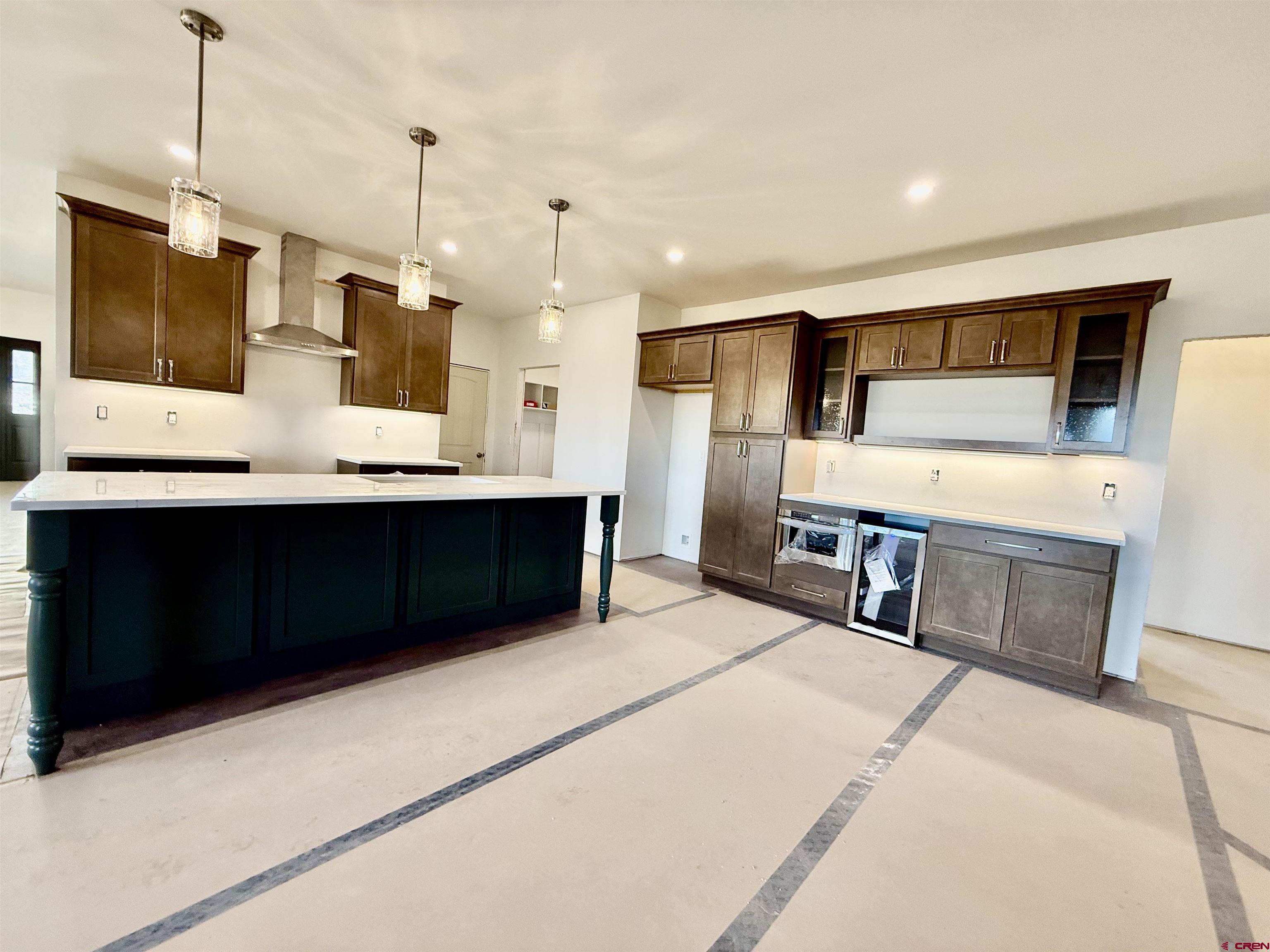 21470 Government Springs Road Montrose, CO 81403 - Photo 6 of 25 a living room with stainless steel appliances kitchen island furniture and a flat screen tv