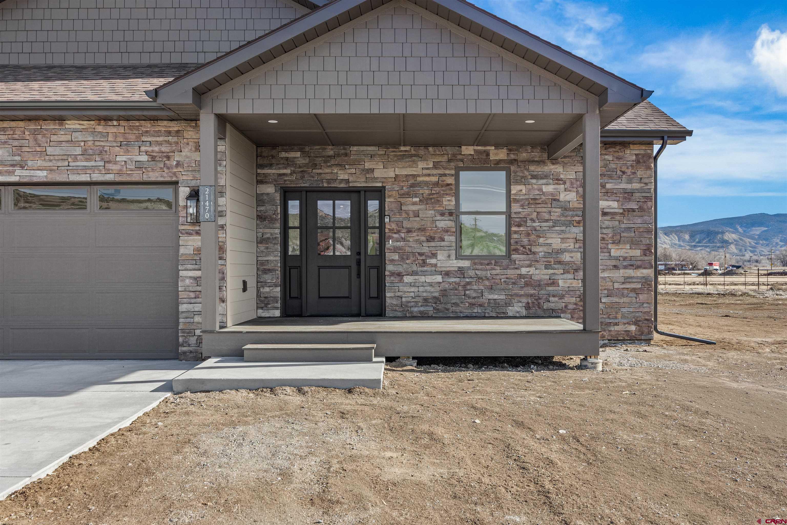 21470 Government Springs Road Montrose, CO 81403 - Photo 9 of 42 a front view of a house with a yard