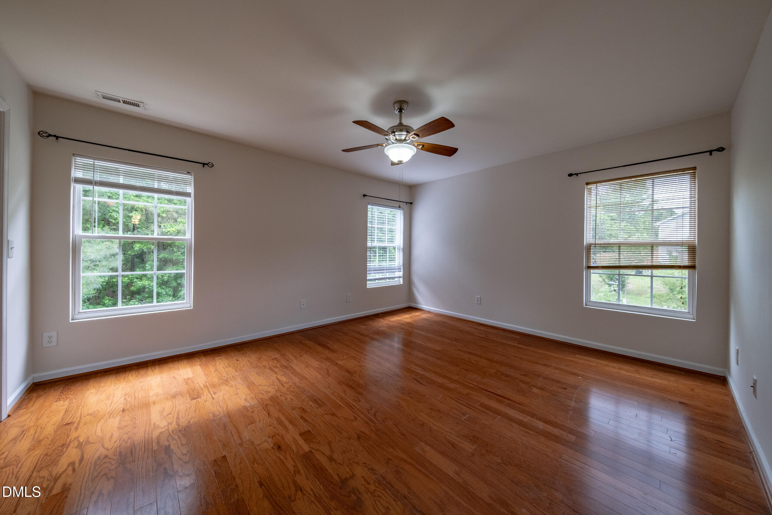 719 Obsidian Way Durham, NC 27703 - Photo 31 of 41 a view of an empty room with wooden floor and a window