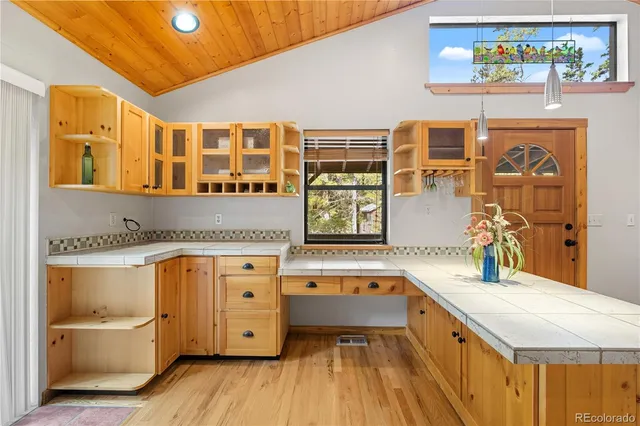a view of empty room with wooden floor and fireplace