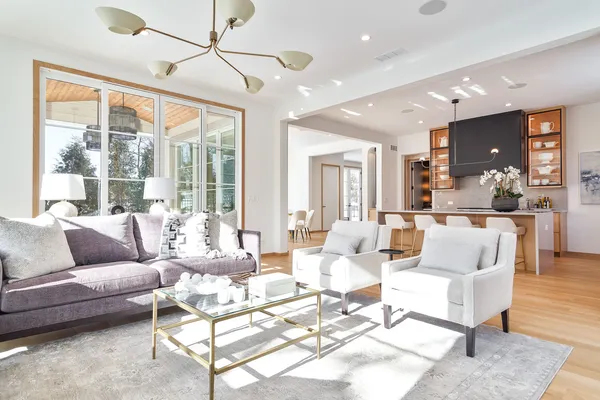 a dining room with furniture a chandelier and wooden floor