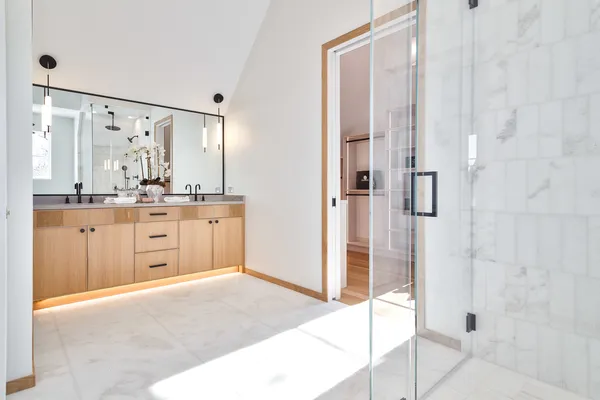a bathroom with a double vanity sink and mirror
