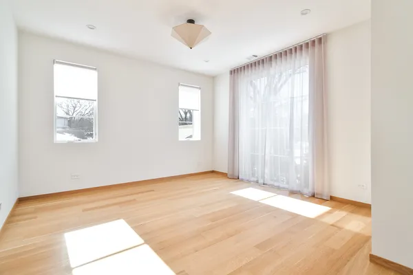 an empty room with windows and closet