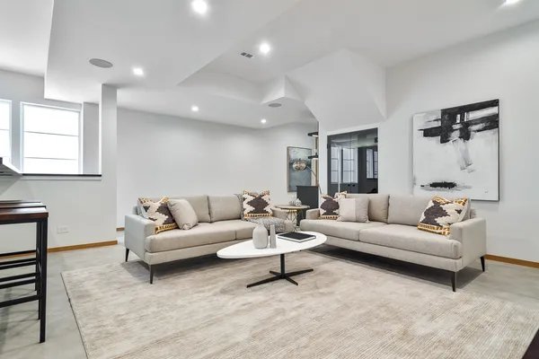 a view of a hallway with livingroom and furniture