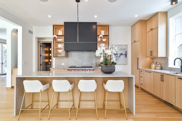 a kitchen with stainless steel appliances kitchen island granite countertop a table and chairs in it