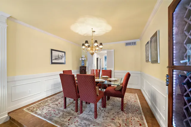 a living room with furniture a rug and a book shelf