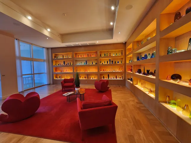 a living room with furniture a rug and a large window