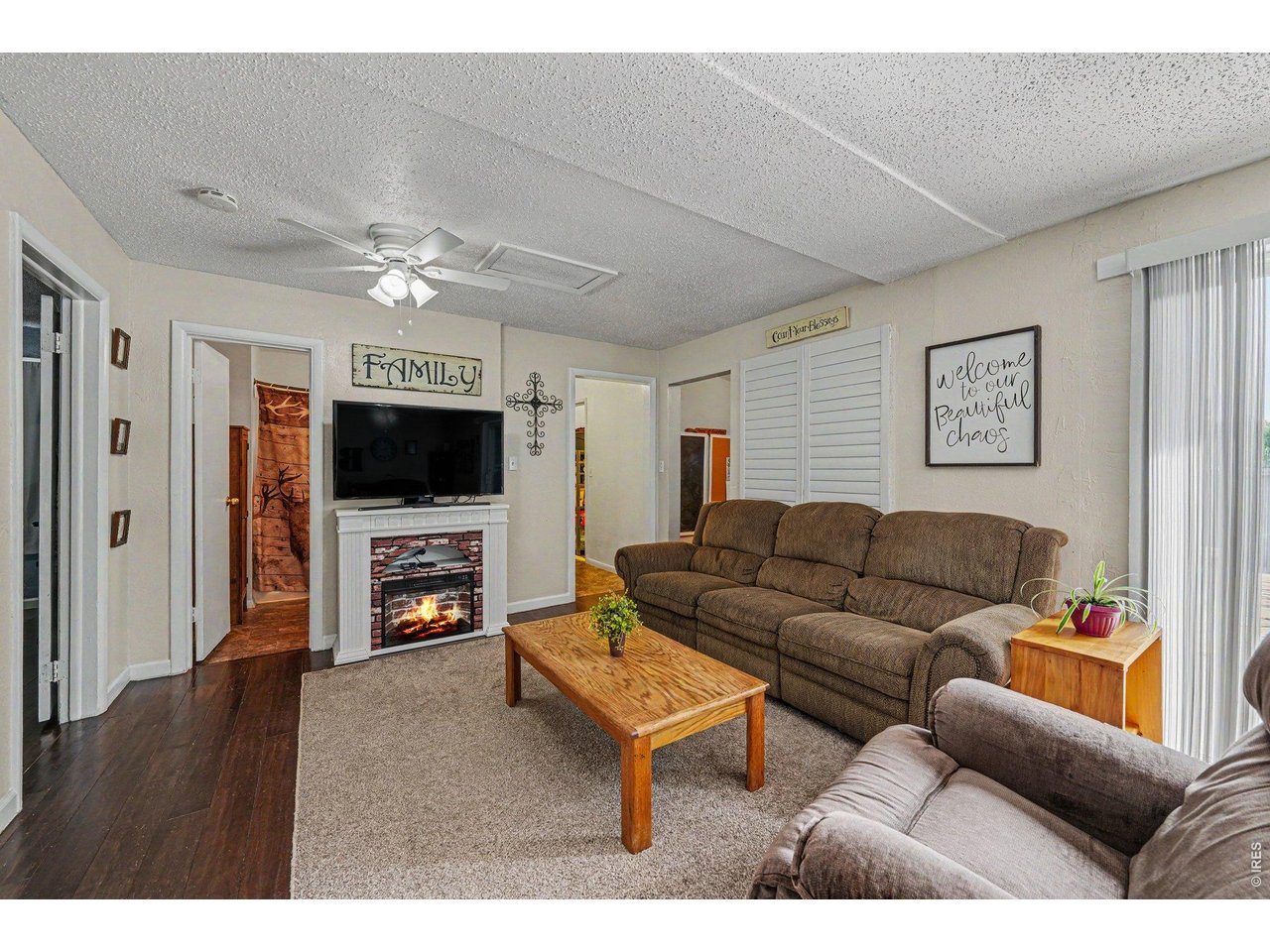1430 30th Street Road Greeley, CO 80631 - Photo 2 of 22 a living room with furniture and a flat screen tv