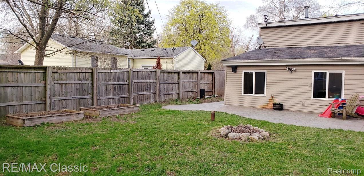9133 Forest Road Whitmore Lake, MI 48189 - Photo 11 of 12 Spacious fenced backyard with stamped concrete patio, raised gardens and firepit.
