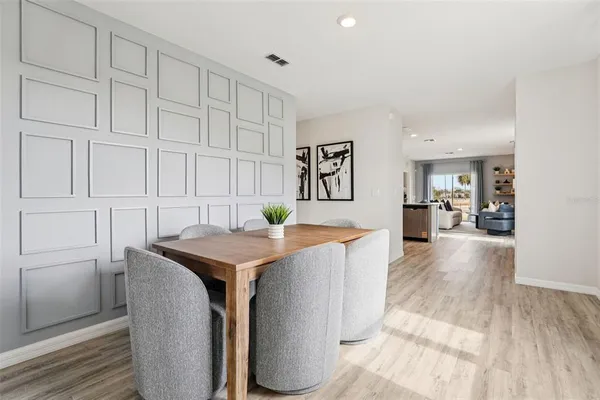 a view of kitchen with furniture and wooden floor