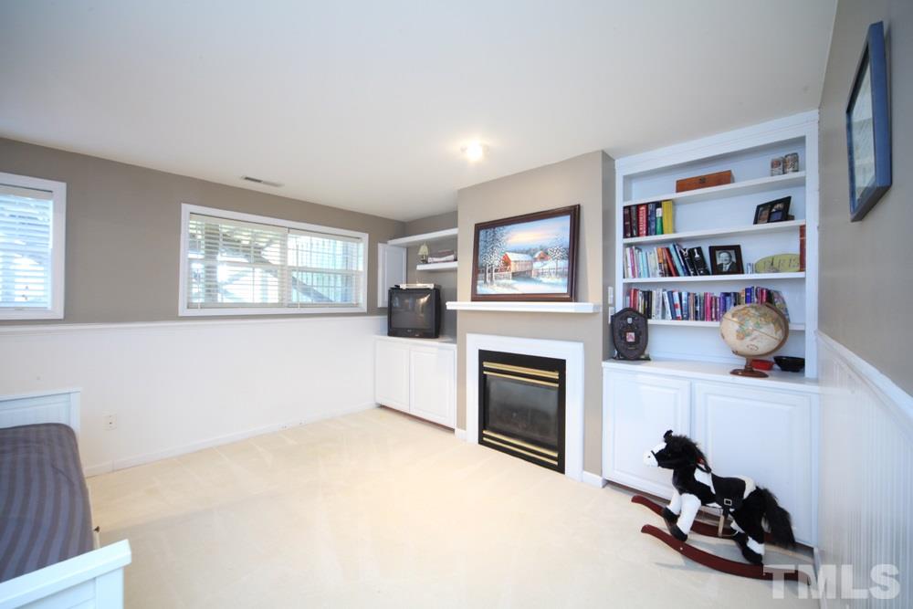 5508 Vista View Court Raleigh, NC 27612 - Photo 5 of 19 Fireplace, built-in cabinets add to the versatility of this space.