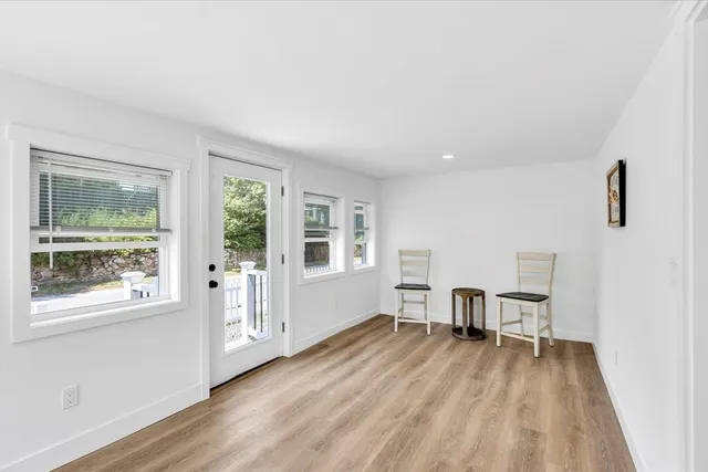 a bathroom with a granite countertop bathtub shower sink vanity and toilet