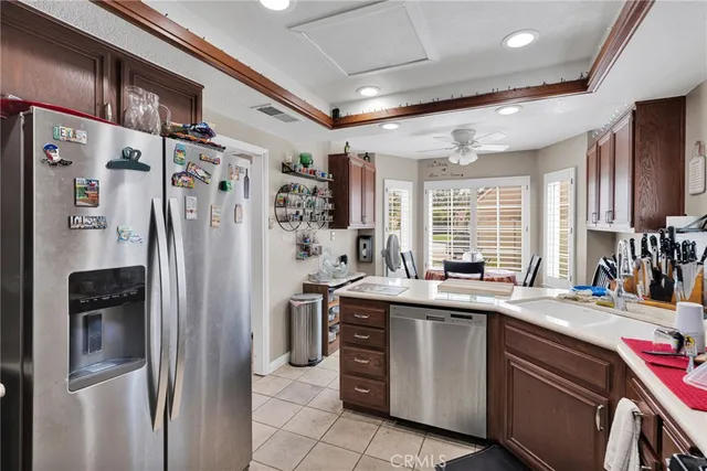 a kitchen with stainless steel appliances granite countertop a refrigerator and a sink