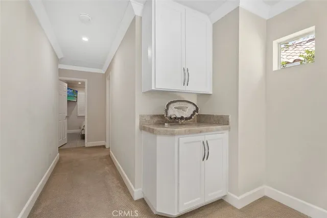 a bathroom with a granite countertop sink a mirror and vanity